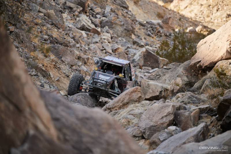 JP Gomez driving through the rocks