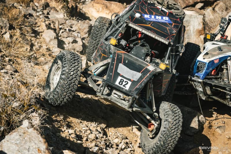 JP Gomez driving over Cameron Steele's wheel in the rocks