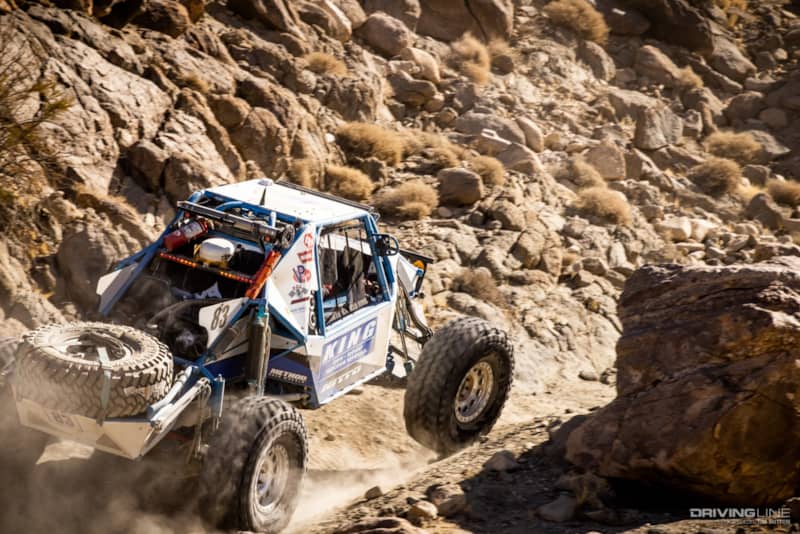 Raul Gomez driving in between large rocks