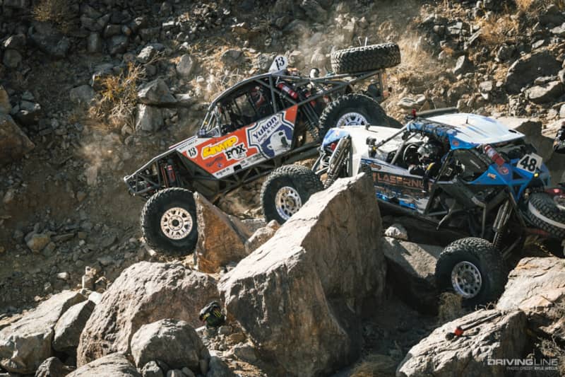 Bailey Cole driving by Cameron Steele's rig through the rocks