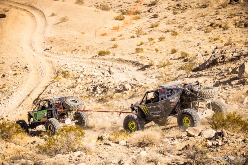 Wayland Campbell getting towed down a hill by another driver