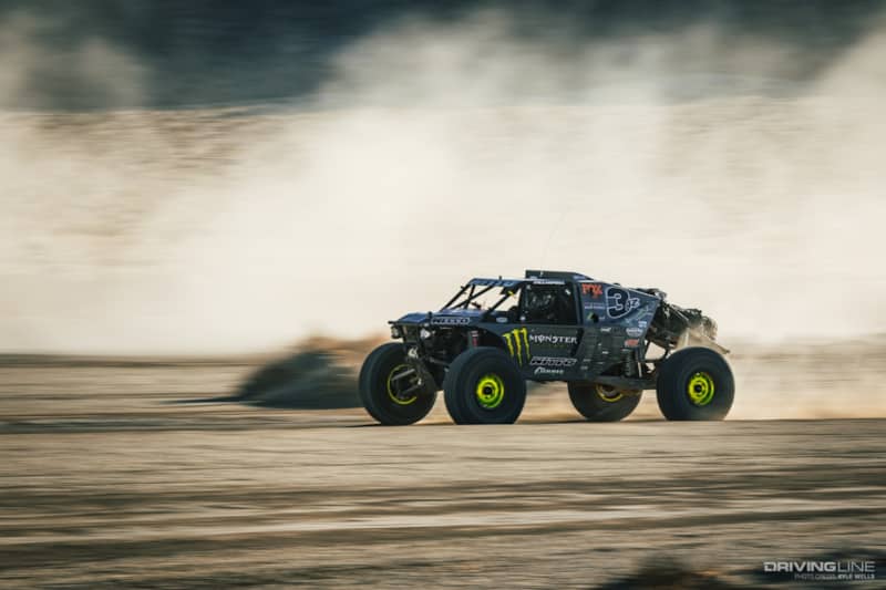 Wayland Campbell driving fast through the desert
