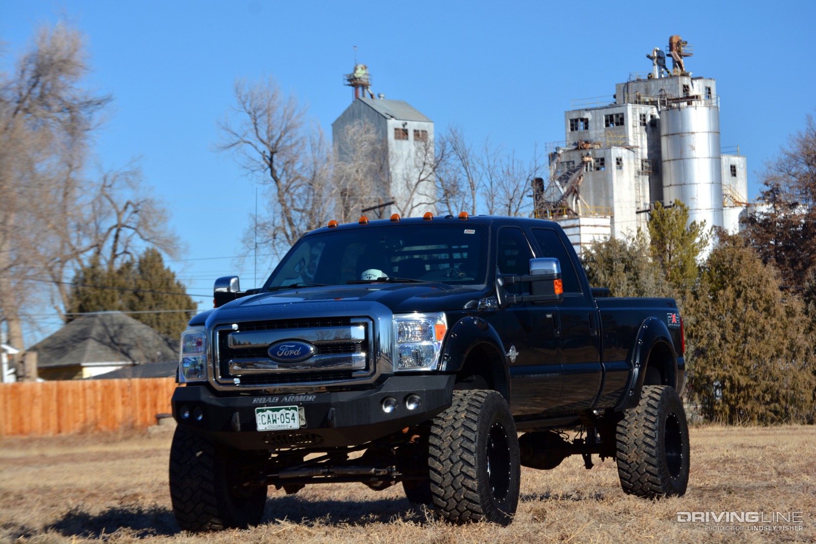 Ford F350 Powerstroke in field in front of silos