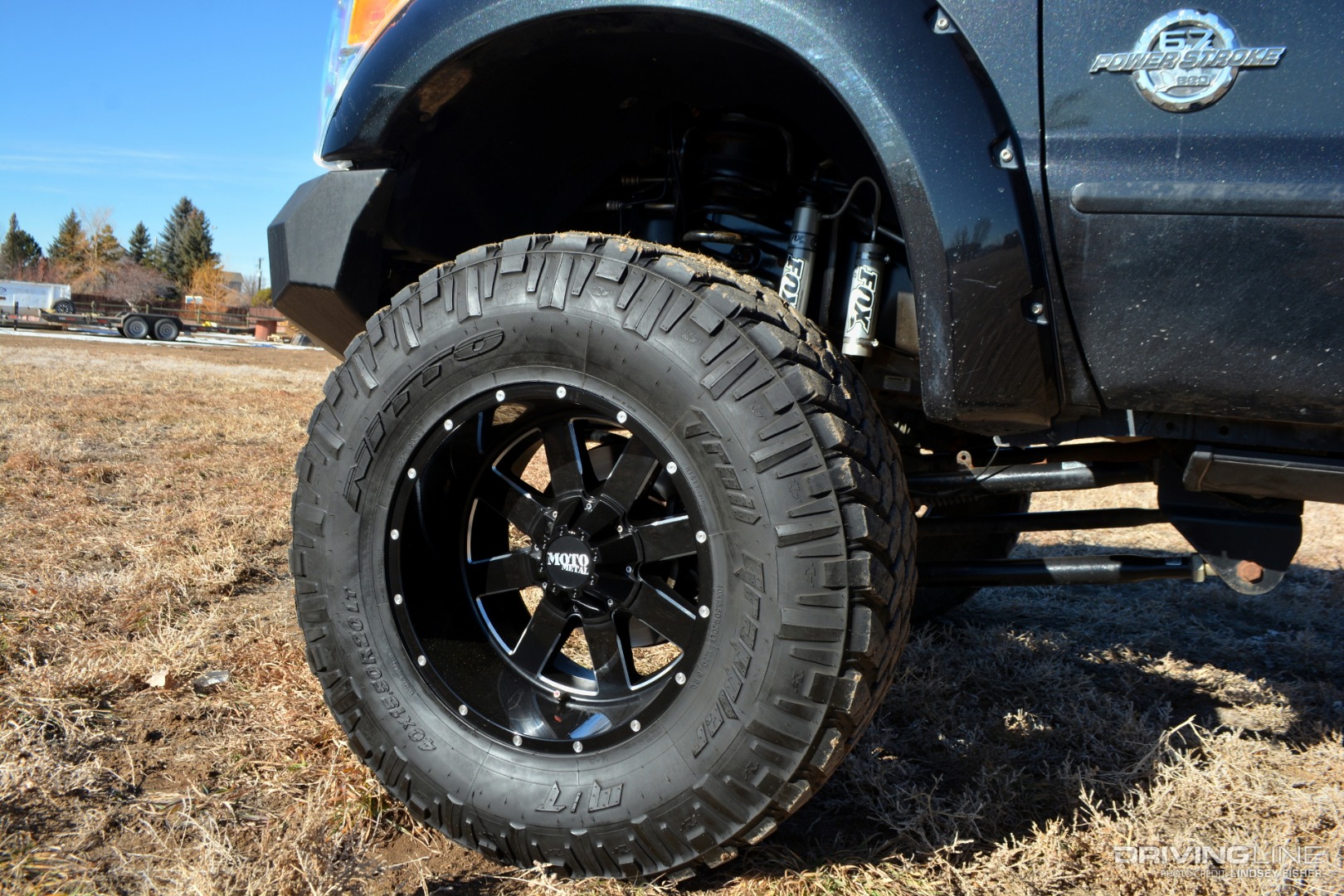 Lifted 2011Ford F350 front tire and front fender in field