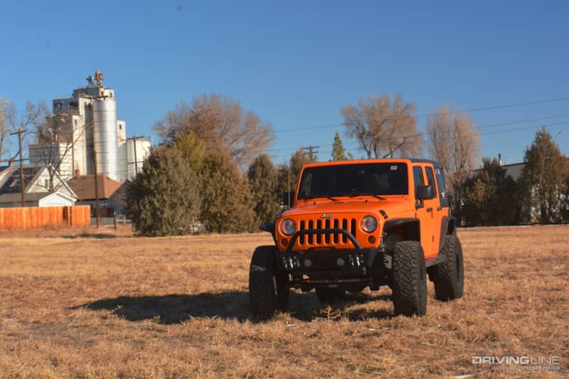 Orange 2013 Jeep Wrangler in Field from Afar
