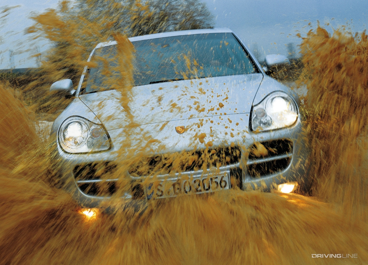 Porsche Cayenne splashing through mud