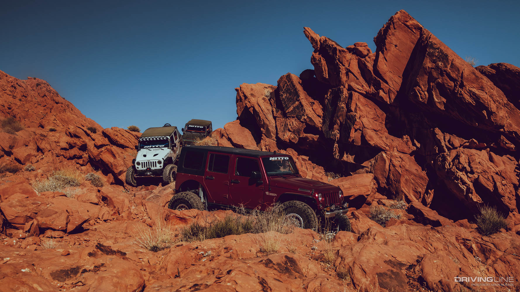 Maroon jeep traversing trails in Logandale Nevada