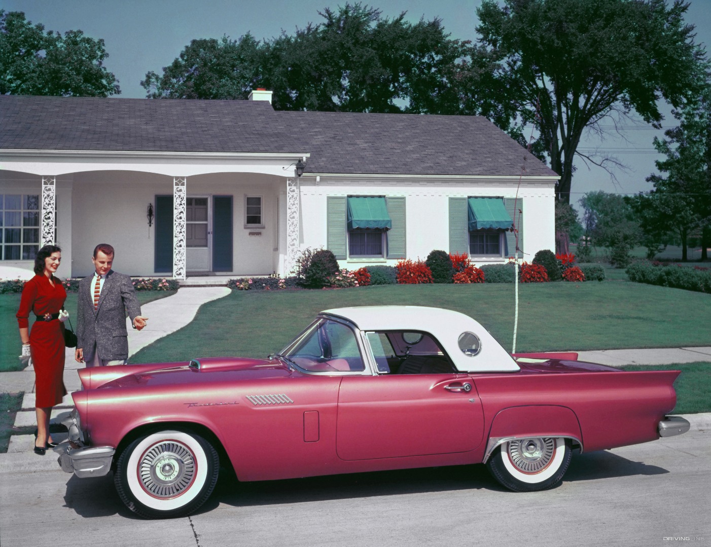 1957 Ford Thunderbird fuschia in front of house