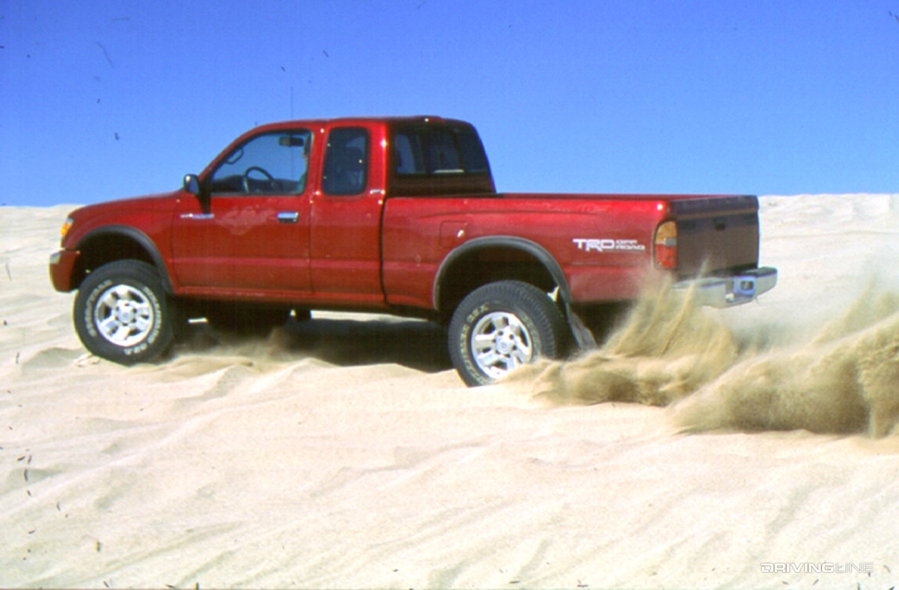 Toyota Tacoma PreRunner drifting through dunes
