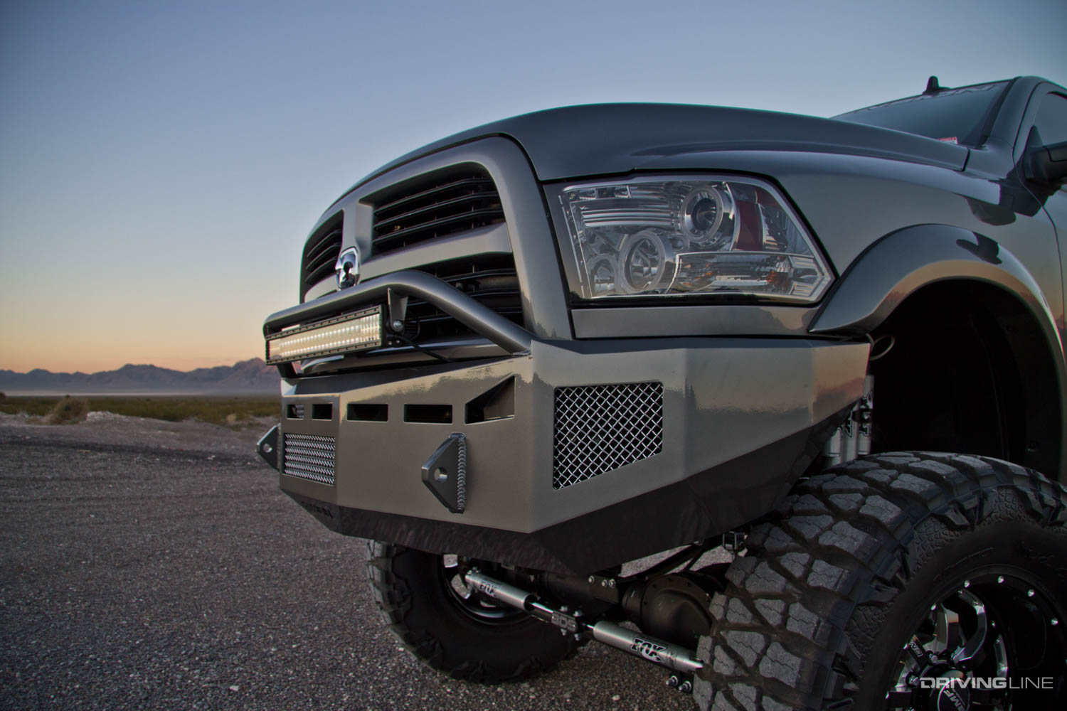 Front end of lifted 2013 Ram 3500 on 40" Nitto Mud Grappler Tires