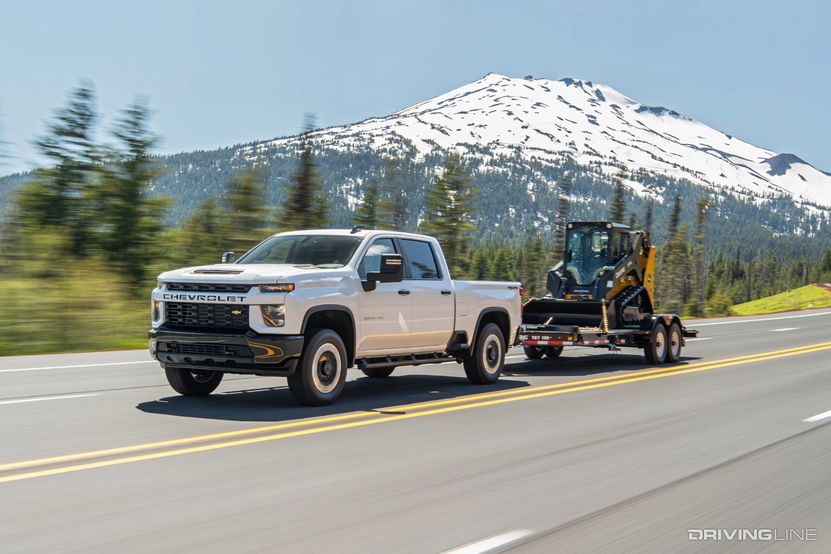 Chevy Silverado towing a bobcat