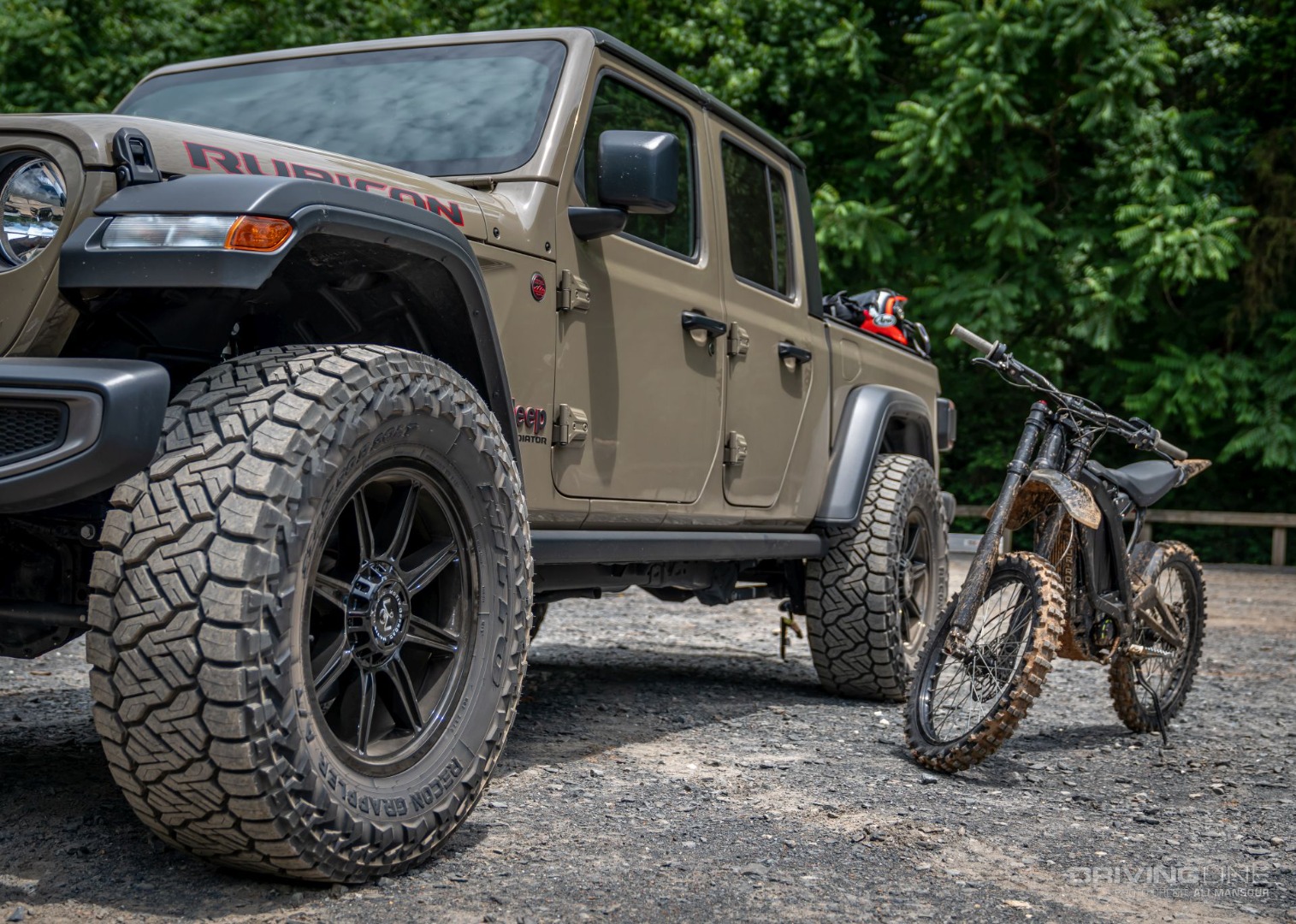 Nitto Recon Grappler all-terrain tires on a Jeep Gladiator next to an electric dirt bike