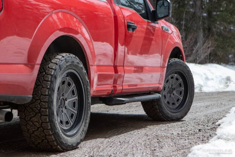 Nitto Recon Grappler A/T tires on a red Ford F-150 pickup truck