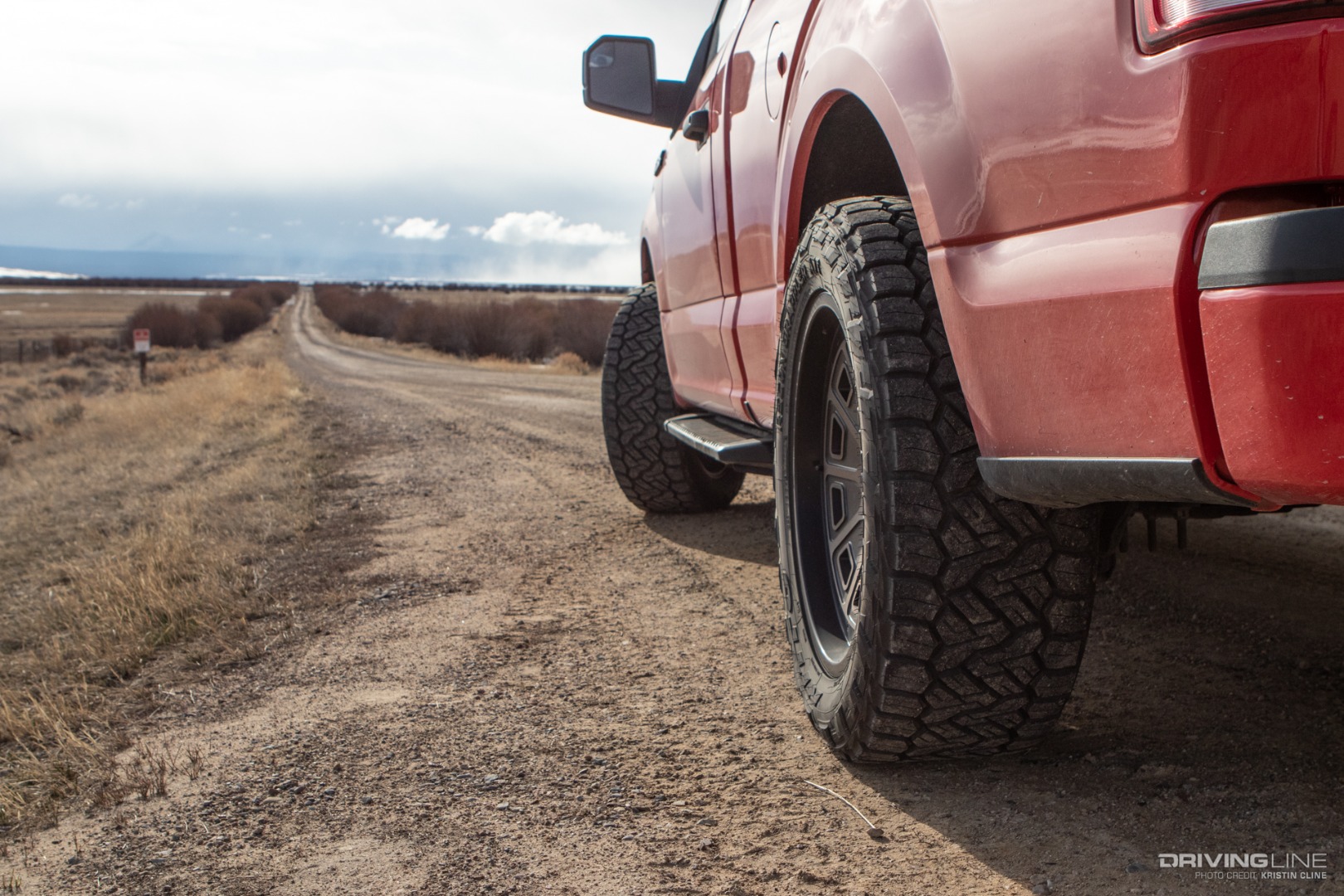 Nitto Recon Grappler A/T Tires on a truck on a dirt road.