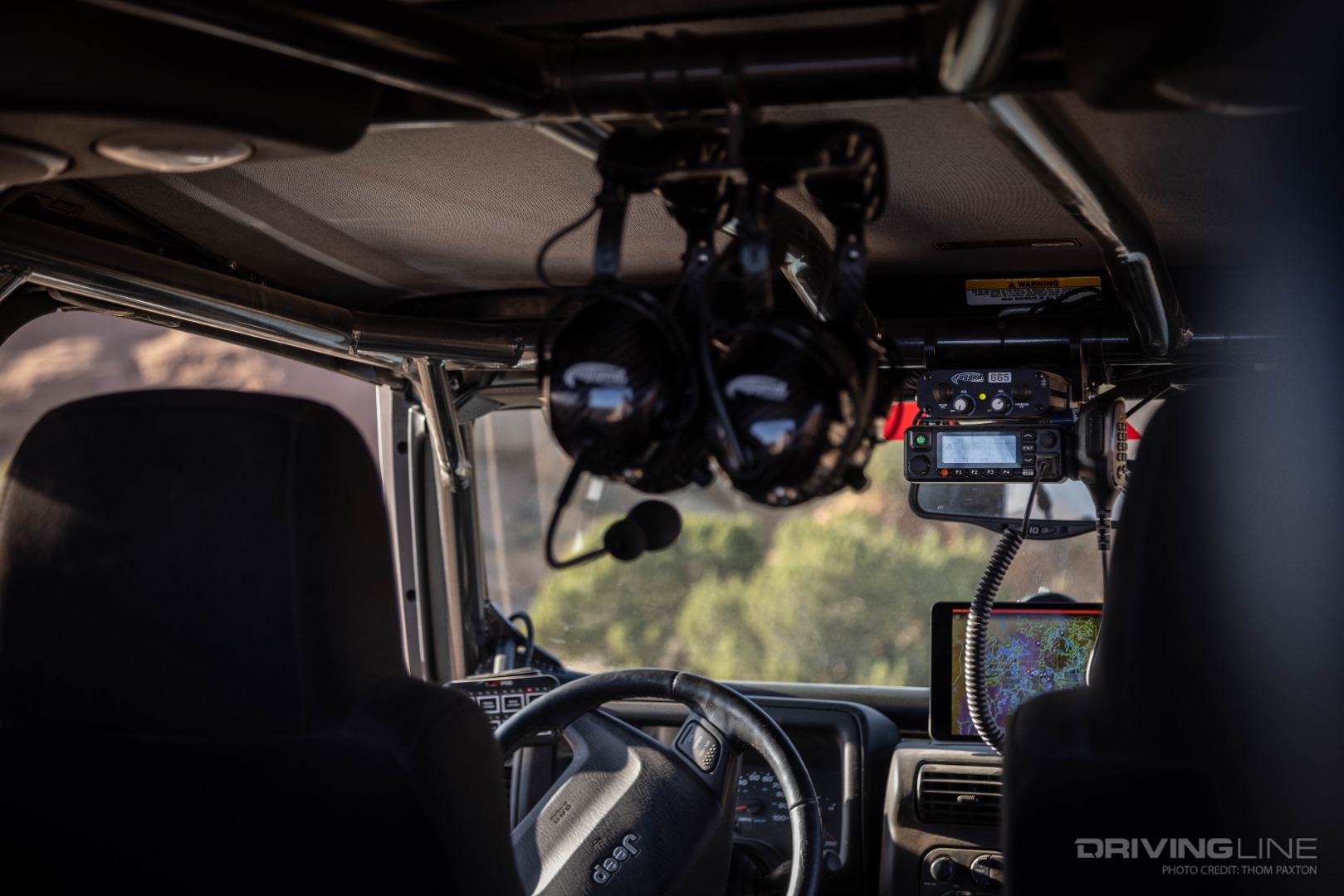 A Genright Off Road Roll Cage, Rugged Radios Setup, onX Offroad, and sPOD Switch Panel all coincide to make for a functional interior setup.