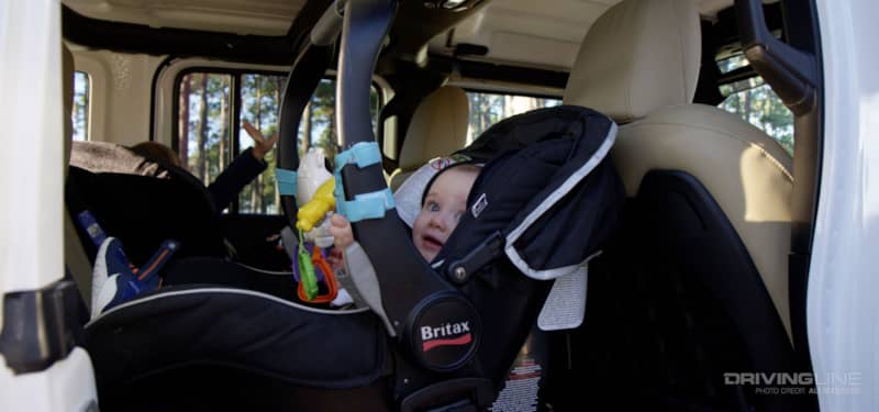 Jeep Wrangler with baby in the backseat