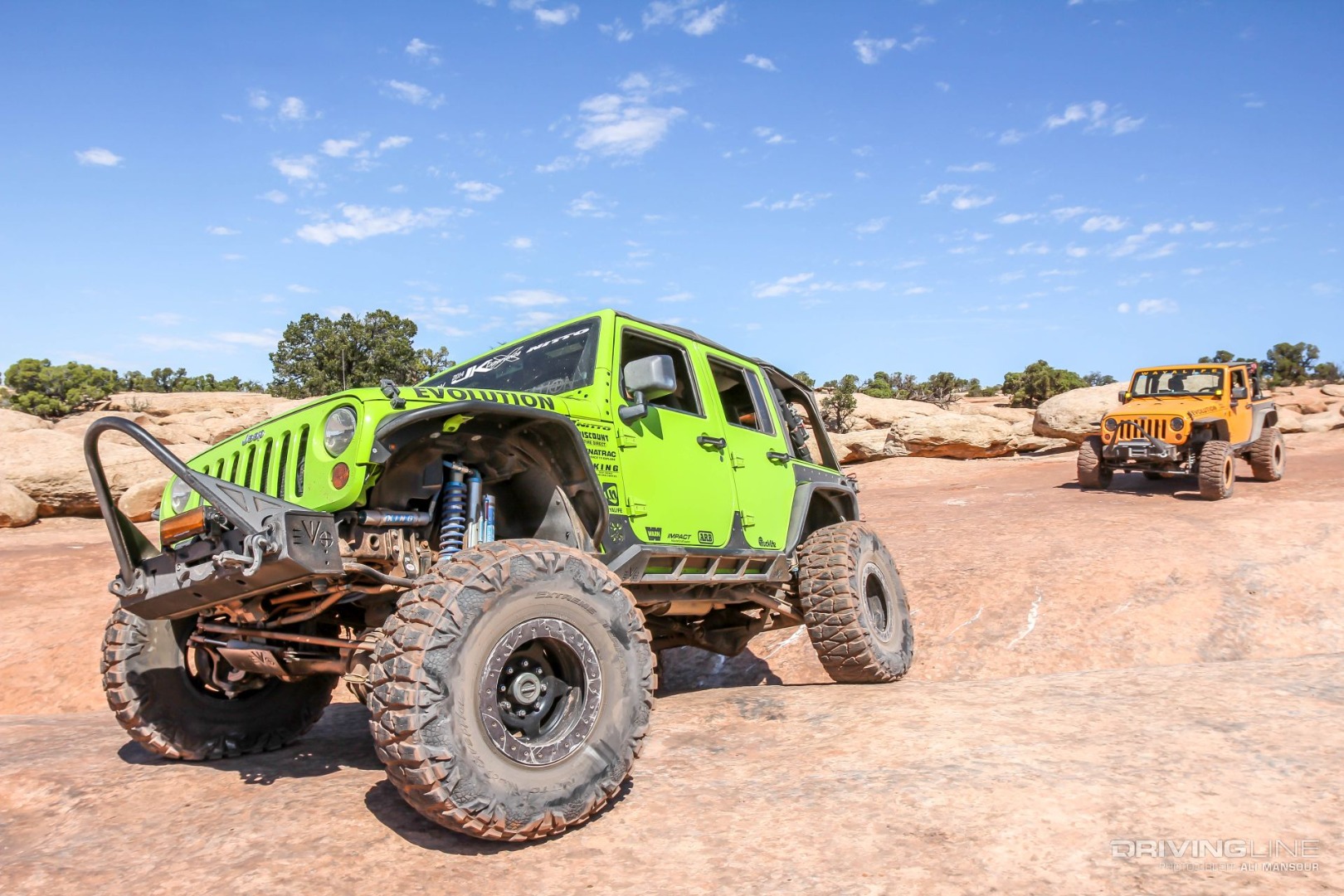 Jeep Wrangler on Nittos in green followed by yellow Jeep Wrangler