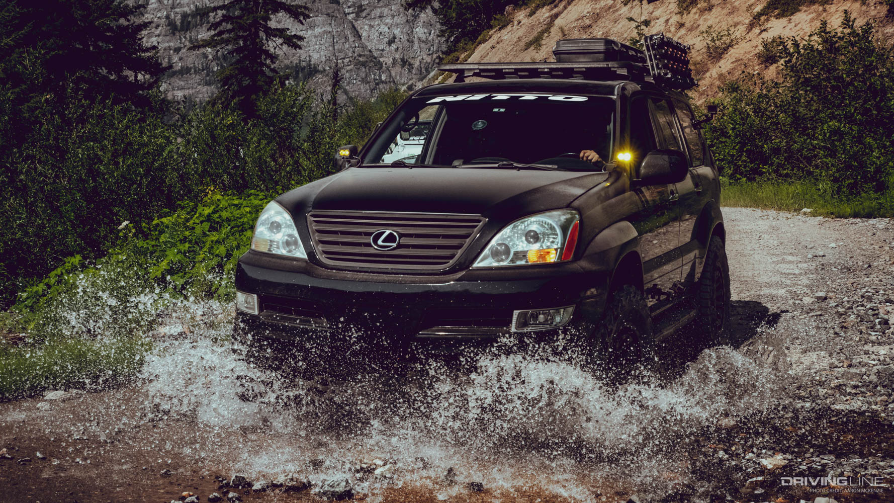 Lexus GX470 driving through a stream