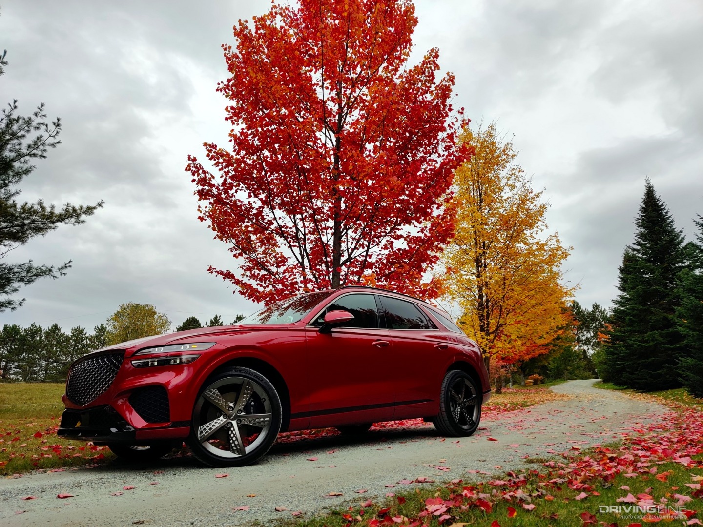 2022 Genesis GV70 with trees on gravel road