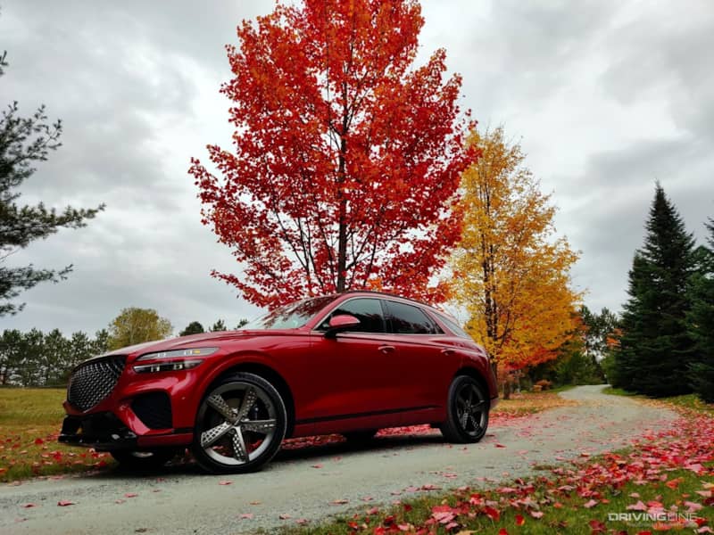 2022 Genesis GV70 with trees on gravel road