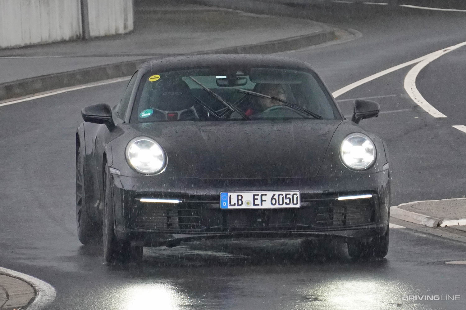 Spy Photos: Upcoming Rally-Inspired, Lifted Porsche 911 Safari front view driving in rain