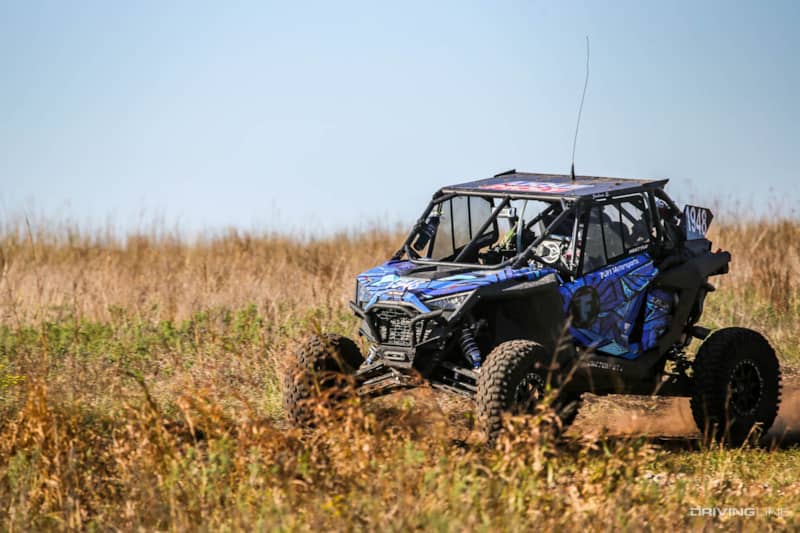 Joshua Smith driving through tall grass