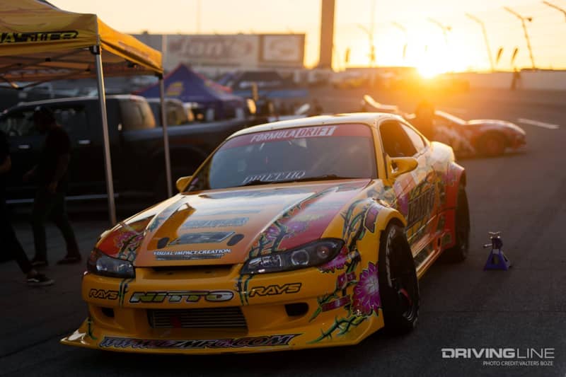 Adam LZ's car jacked up in the pits at sunset