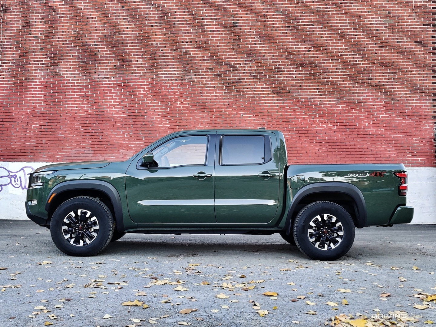 2022 Nissan Frontier profile in front of brick wall