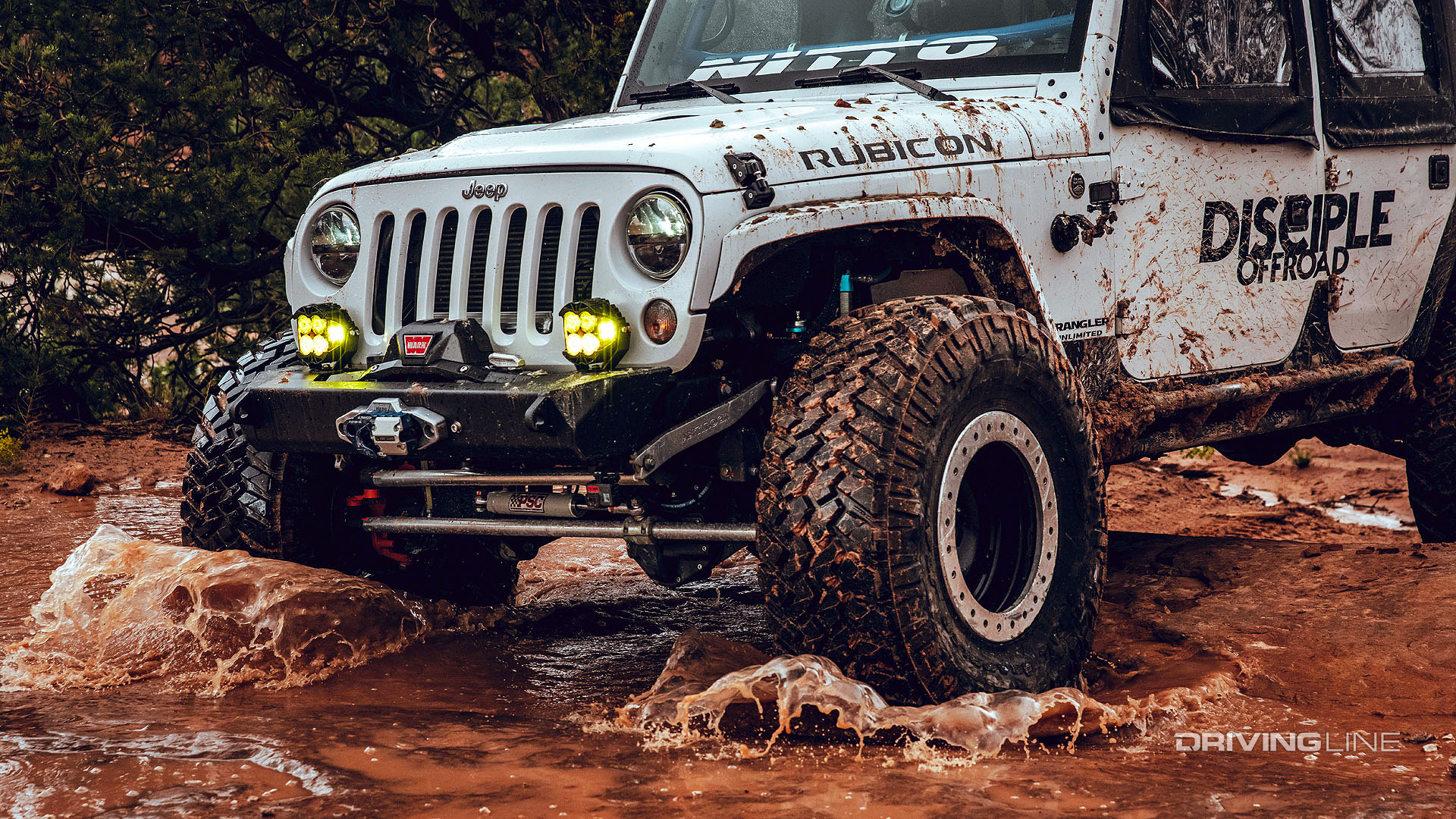 Jeep Rubicon off-roading in water and mud