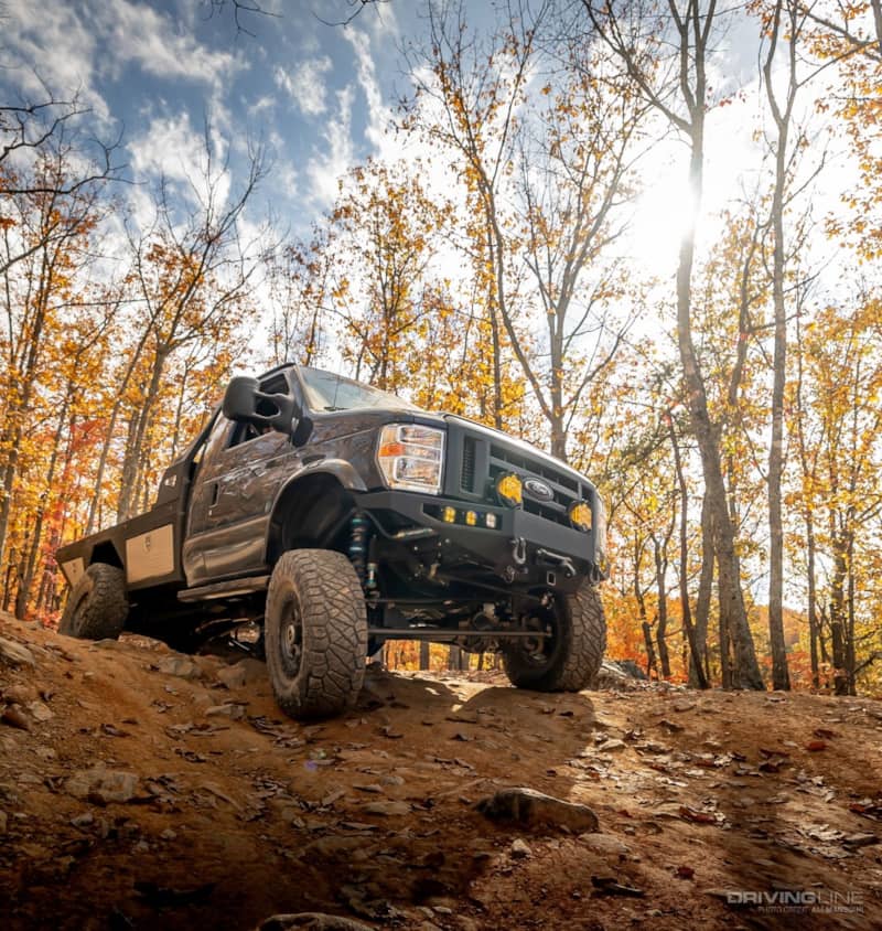 2021 Ford E350 4x4 flatbed van driving off-road