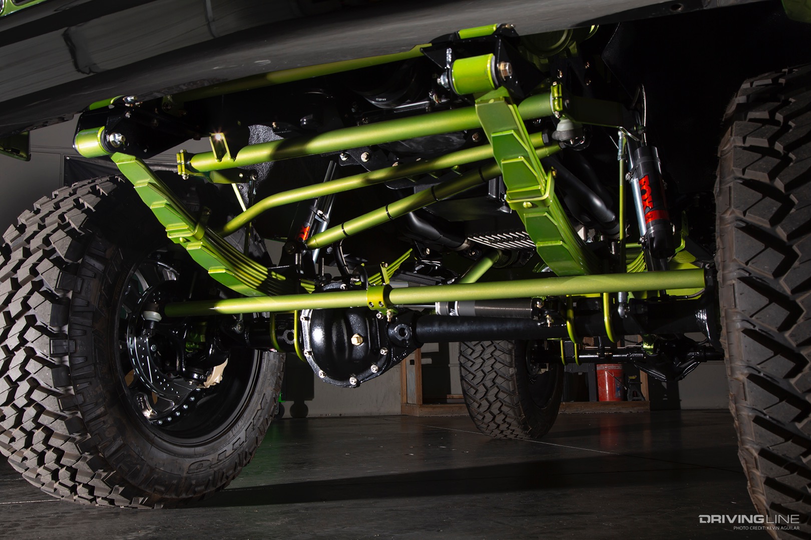 green painted leaf springs on lifted truck with Nitto Trail Grappler tires