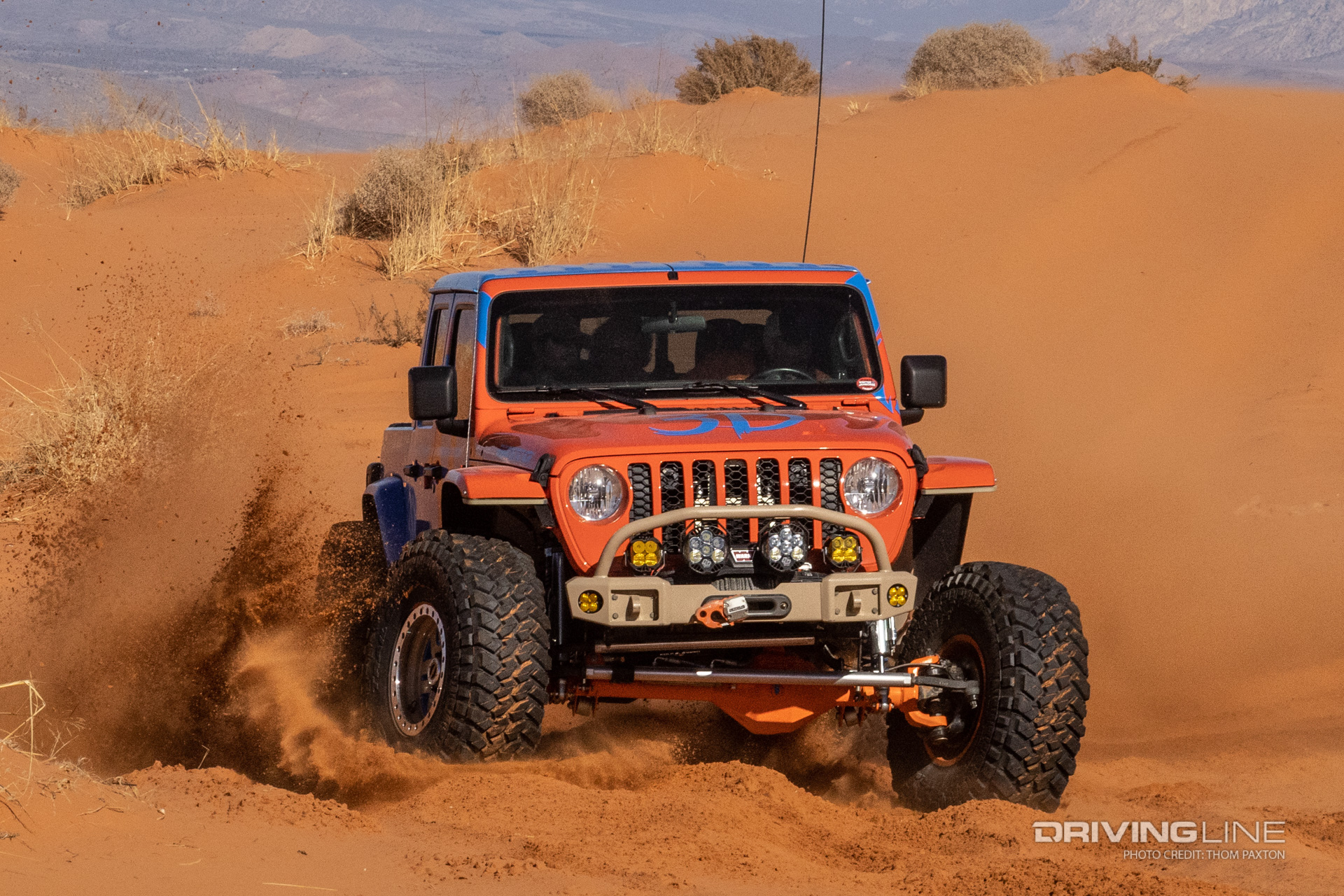Front of Blaze JT Gladiator kicking up sand with front tires