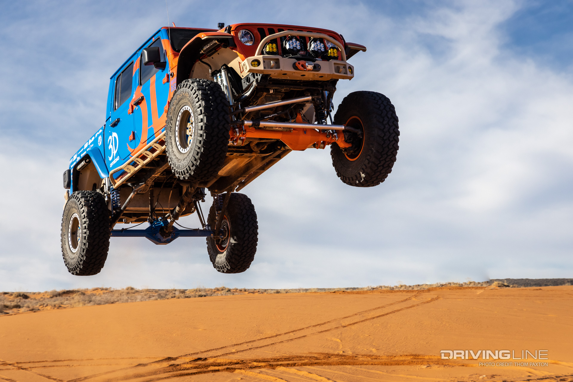 Blaze JT Gladiator getting a ton of air over a sand dune