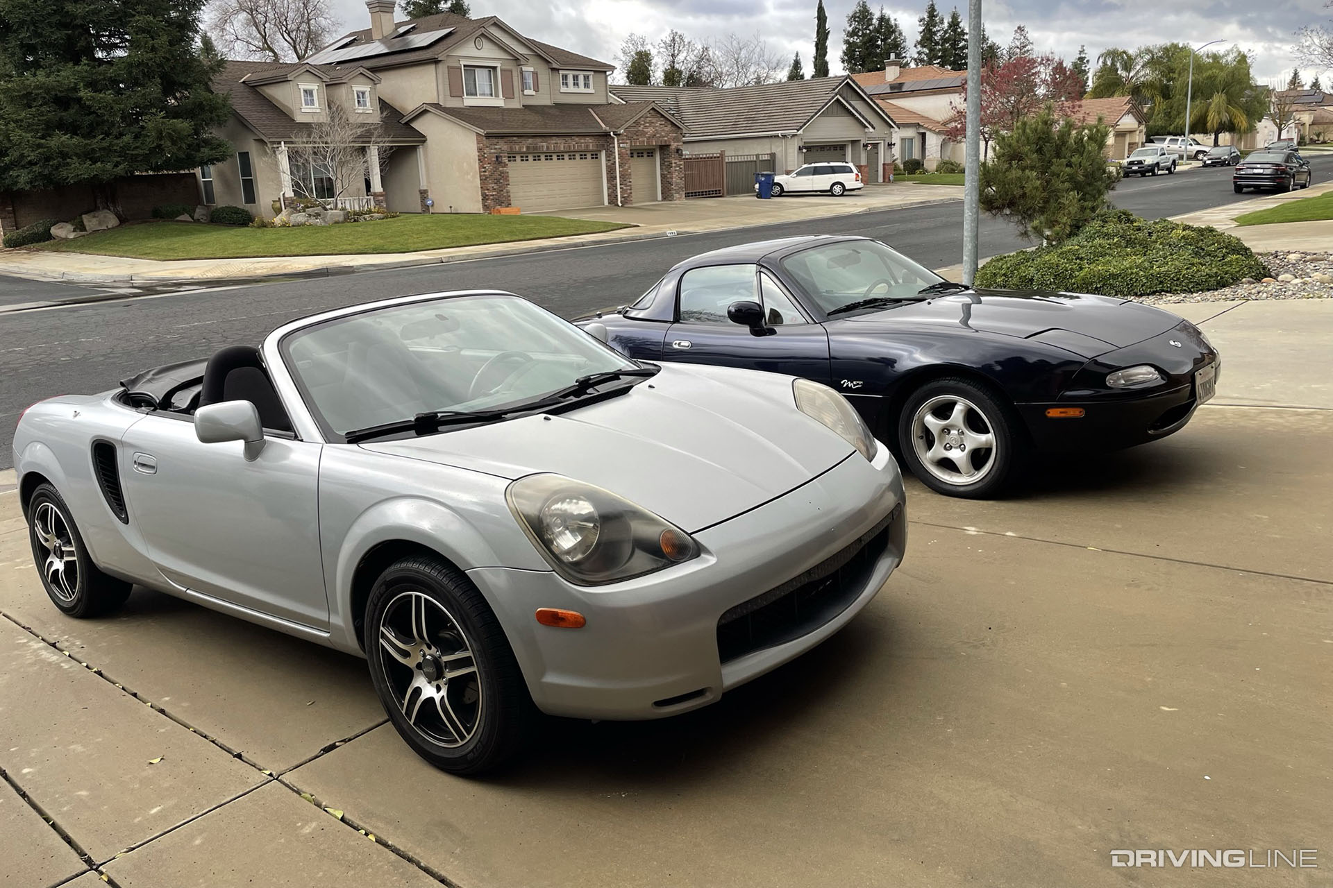 Toyota MR2 Spyder and Mazda Miata in a driveway
