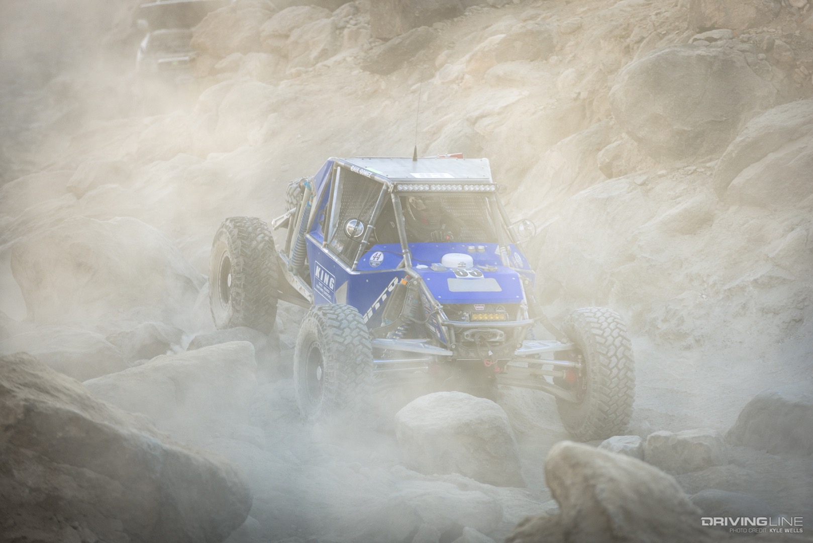 Raul Gomez driving through a dusty canyon