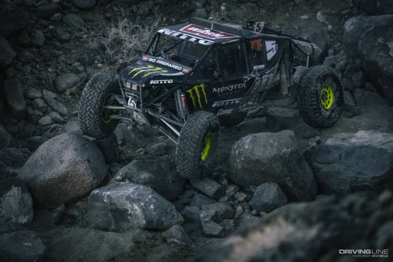 Shannon Campbell navigating down some boulders