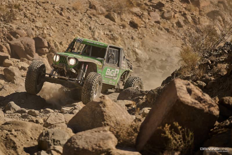Rusty Blyler drives over boulders in a canyon