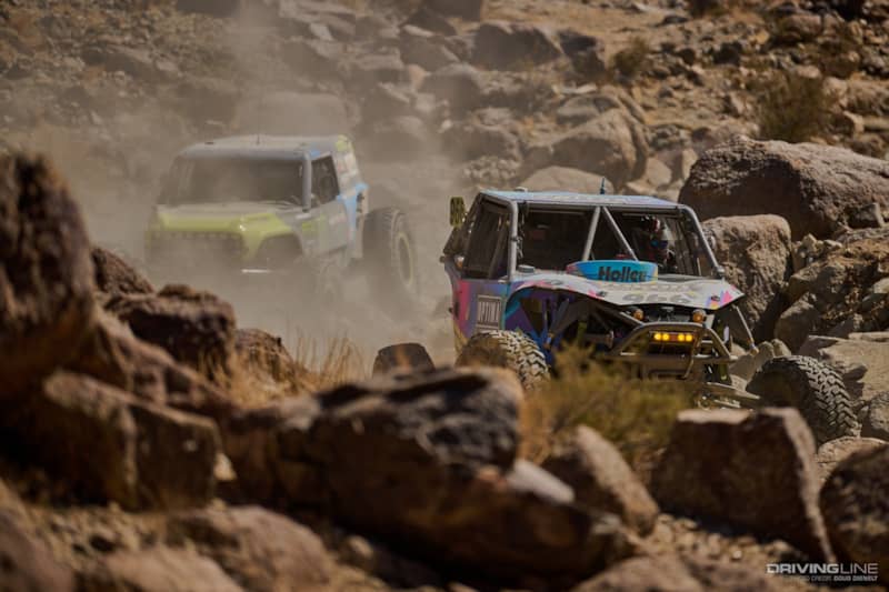 Jason Blanton driving down a rocky canyon ahead of Vaughn Gittin Jr.