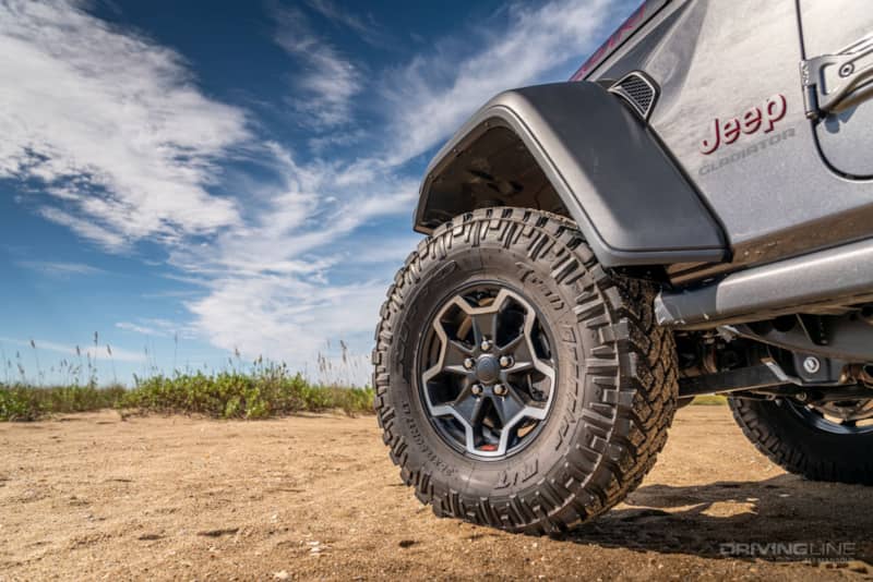 front wheel of a Jeep on sandy beach with 35-inch Nitto Trail Grappler Tires