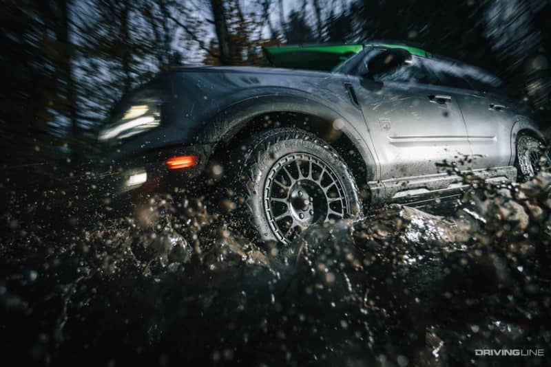 Nitto Nomad Grappler all-terrain crossover tire driving through muddy water