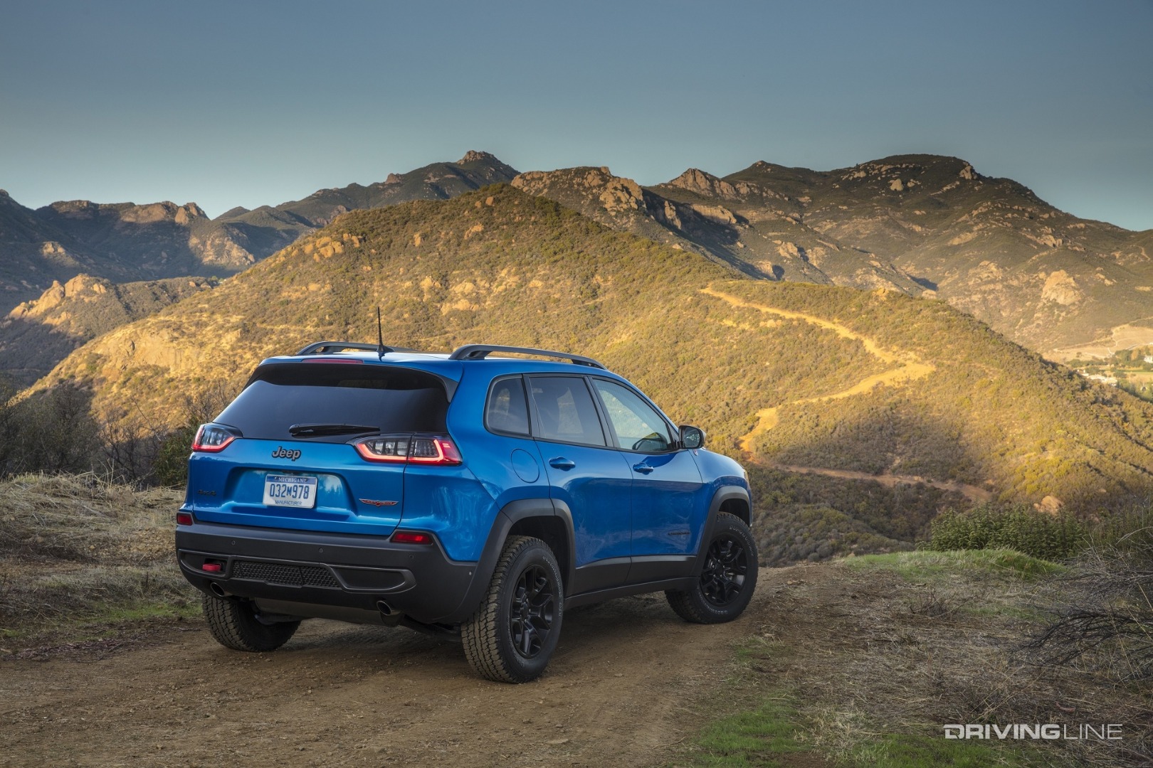 Jeep Cherokee Trackhawk blue from behind mountain range