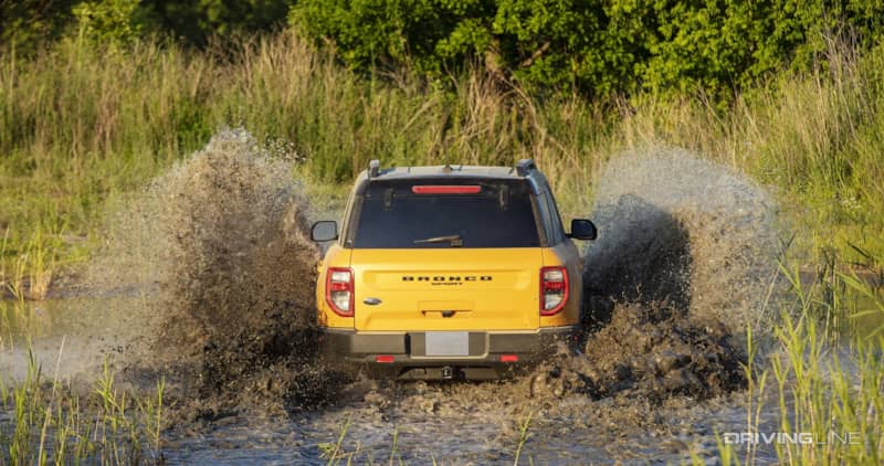 Ford Bronco Sport Badlands yellow from behind in mud
