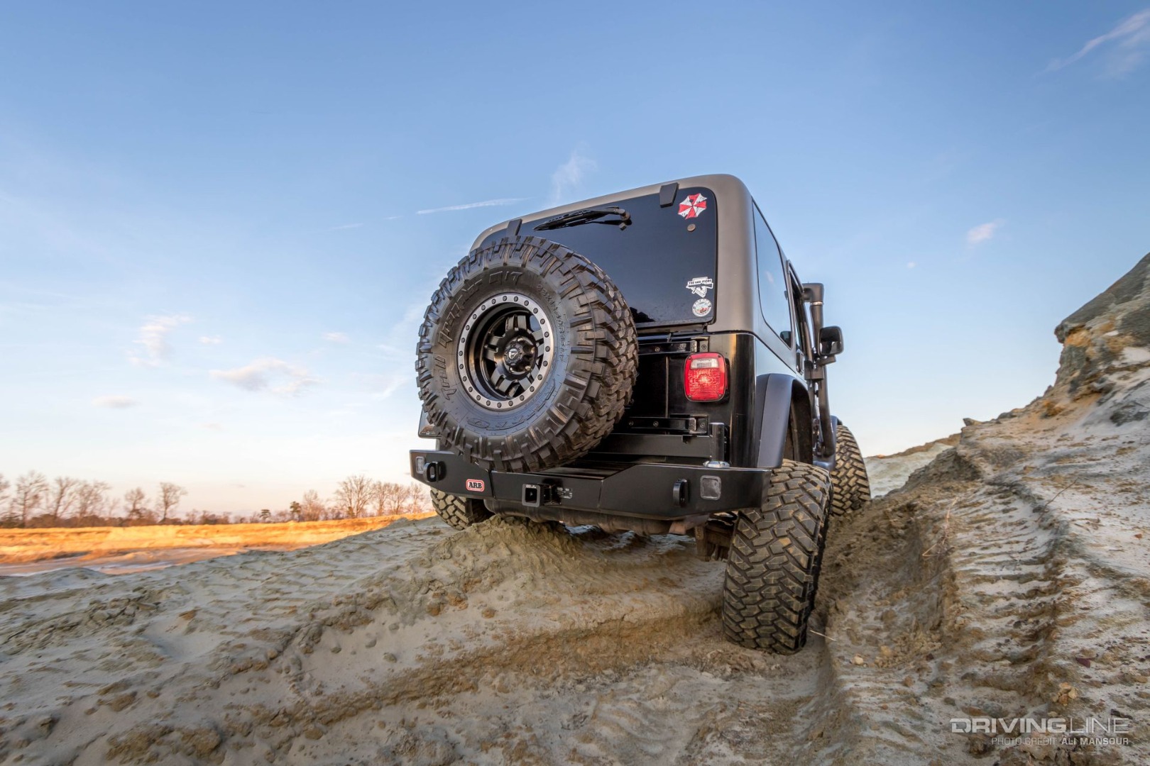 Jeep Wrangler TJ on Nittos from behind on sand