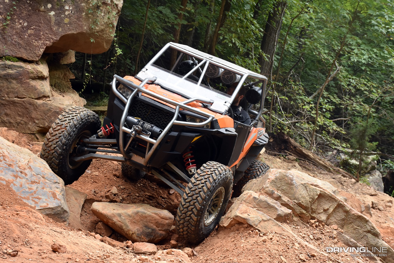 64" RZR crawling between rocks