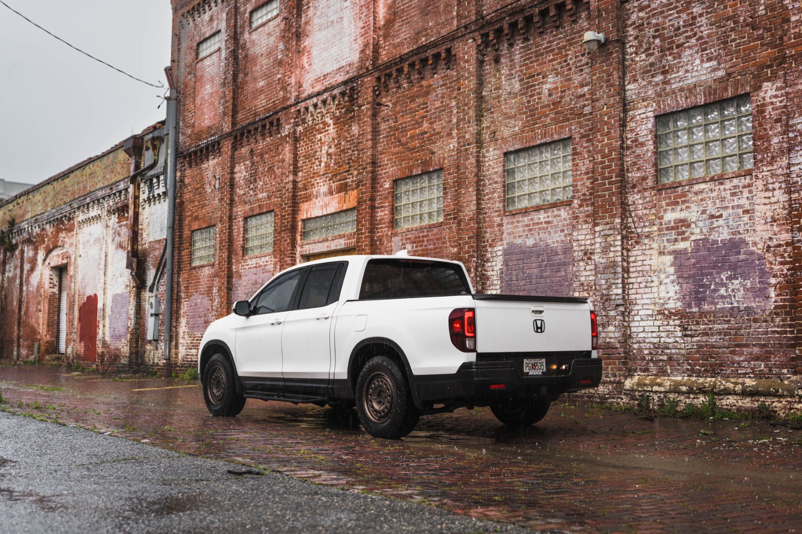 Honda Ridgeline with 1.5" lift next to a brick building