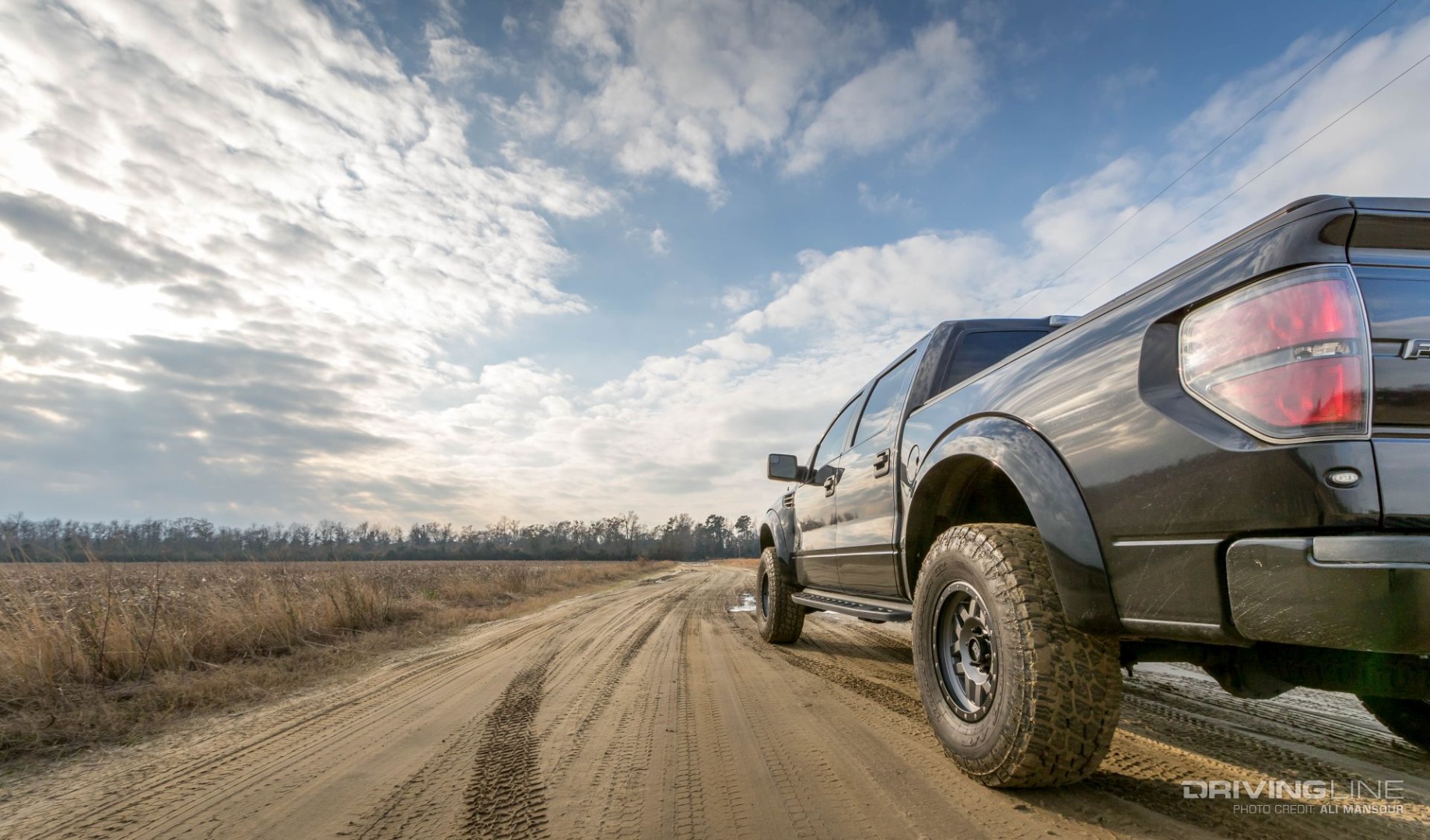 Ford F-150 SVT Raptor on Nittos from behind long view