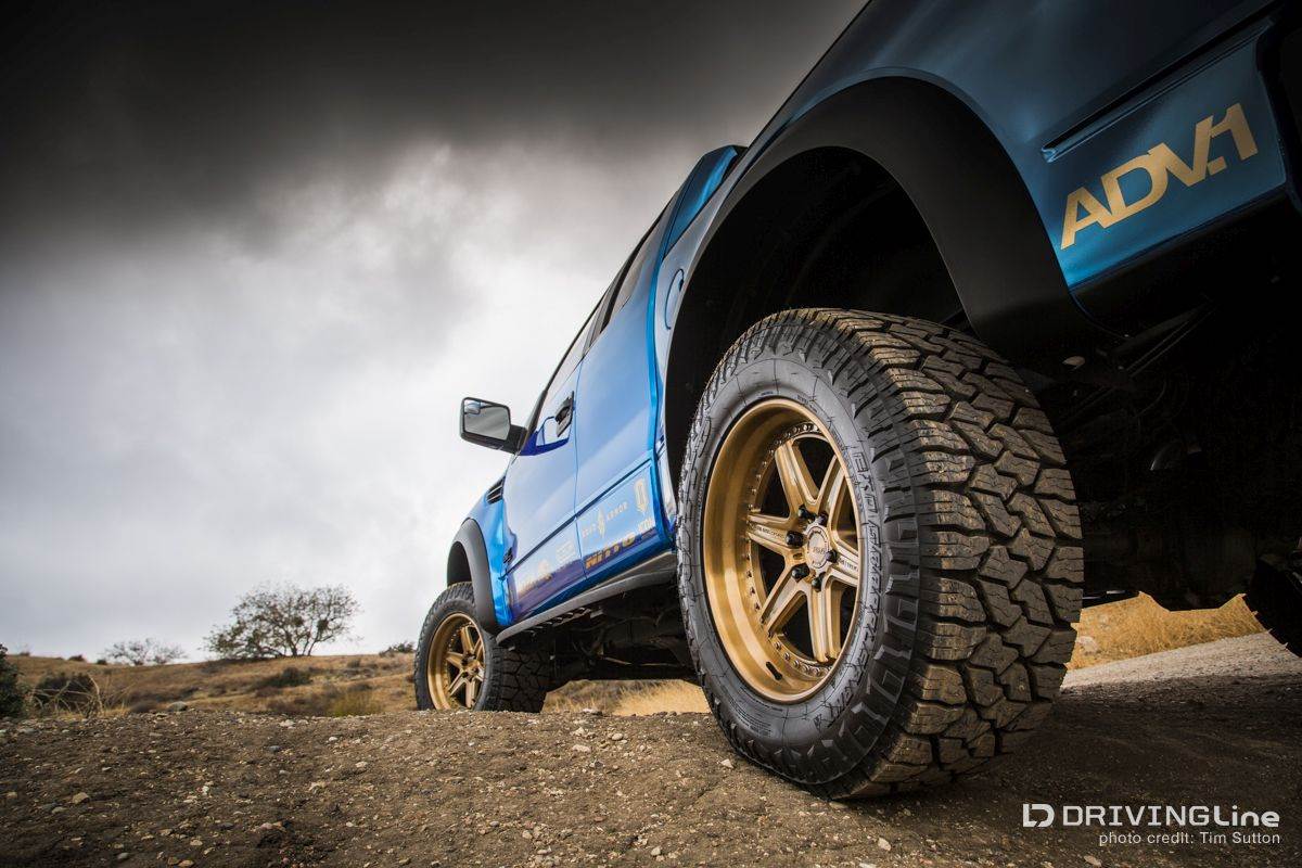 Ford F-150 SVT Raptor on Nittos in blue from low 3/4 rear