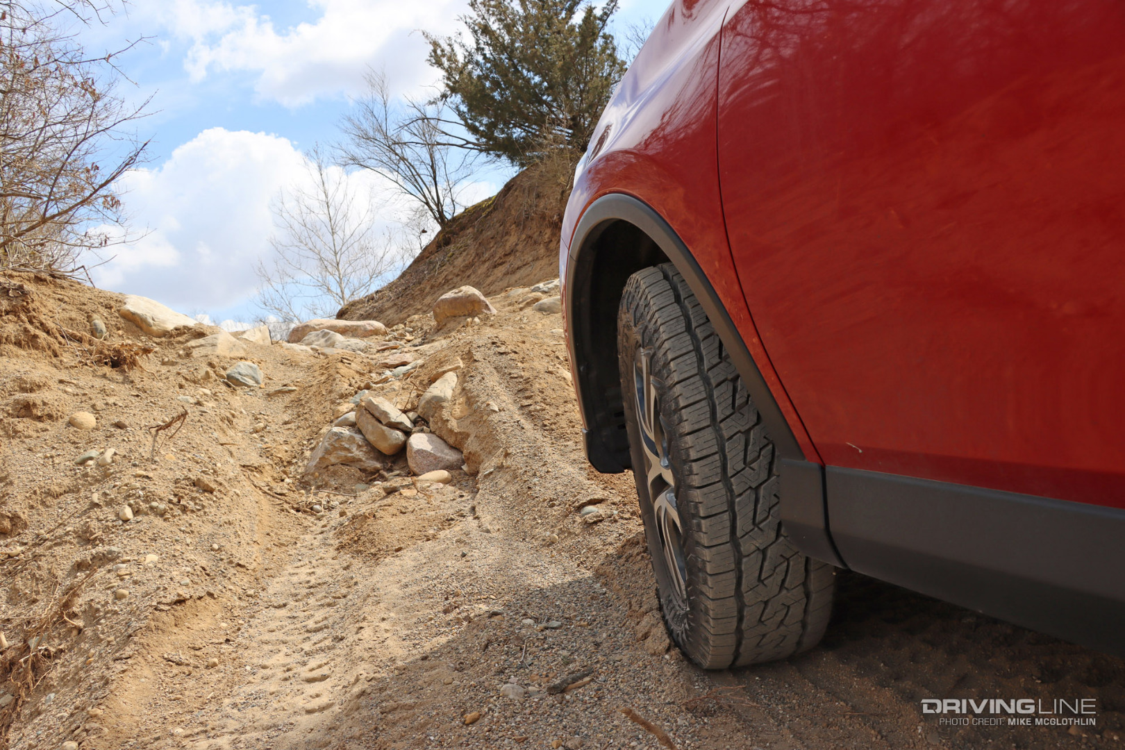 Off Road Nomad Grappler Nitto Tires on RAV4 going up a hill off-road