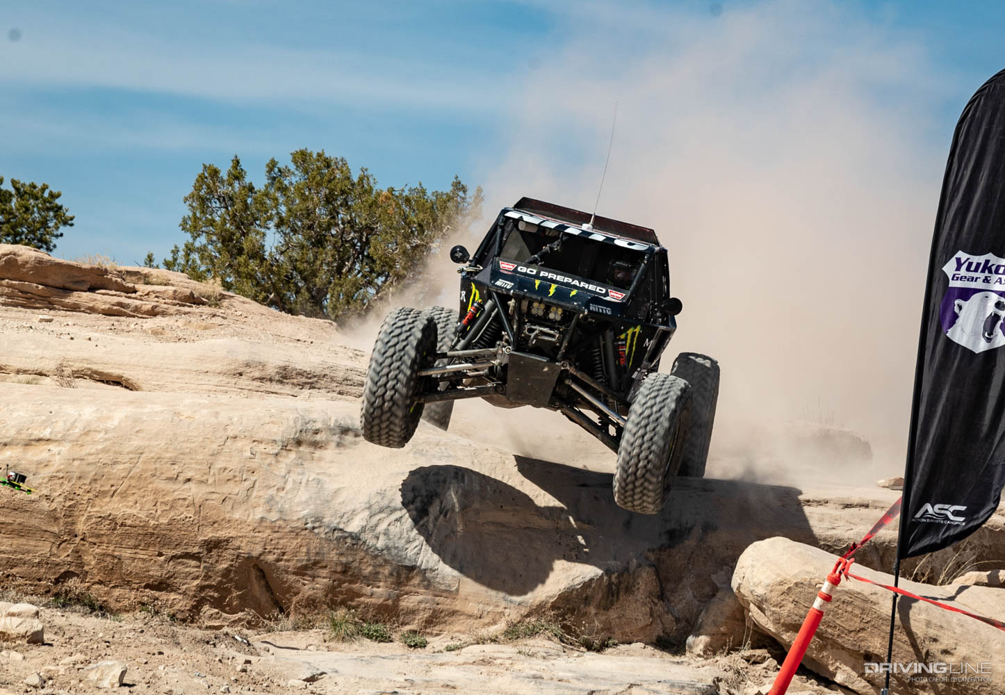 Shannon Campbell launching his Ultra4 car off the rocks in Moab 2022