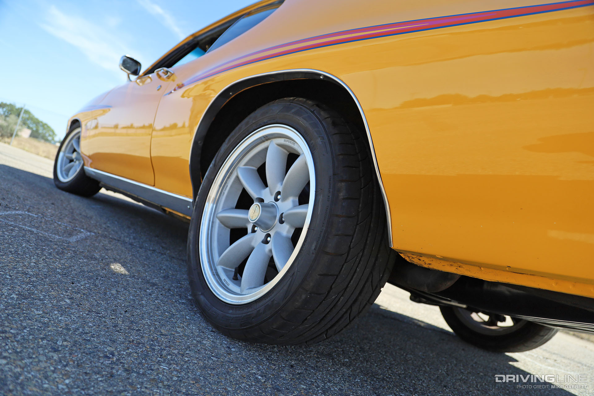 driver side view of yellow 1970 Pontiac GTO on Nitto NT555 G2